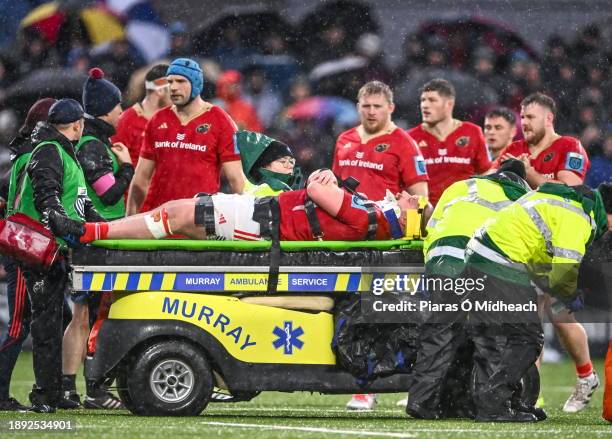 Galway , Ireland - 1 January 2024; Oli Jager of Munster is escorted off the pitch in a medical cart during the United Rugby Championship match...