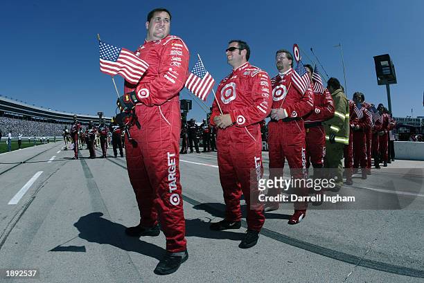 Crew members for the Target Chip Ganassi Racing Dodge Intrepid of Casey Mears carry the flag of the United States during the pre race ceremonies at...