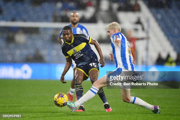 Jack Rudoni of Huddersfield Town challenges Anfernee Dijksteel of Middlesbrough during the Sky Bet Championship match between Huddersfield Town and...