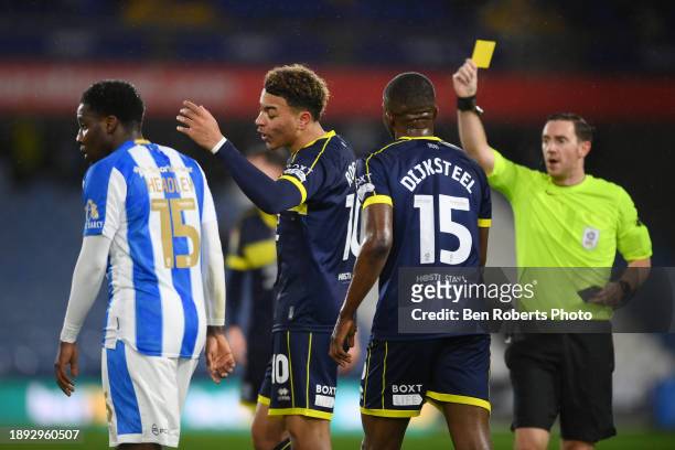 Morgan Rogers of Middlesbrough receives a yellow card during the Sky Bet Championship match between Huddersfield Town and Middlesbrough at John...