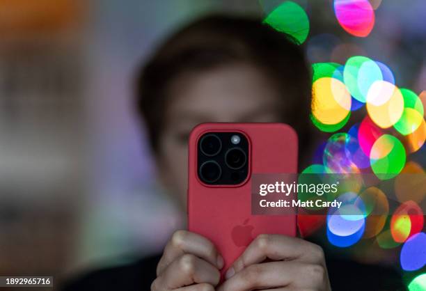 Year-old boy looks at an iPhone screen on December 19, 2023 in Bath, England. The amount of time children spend on screens each day rocketed during...