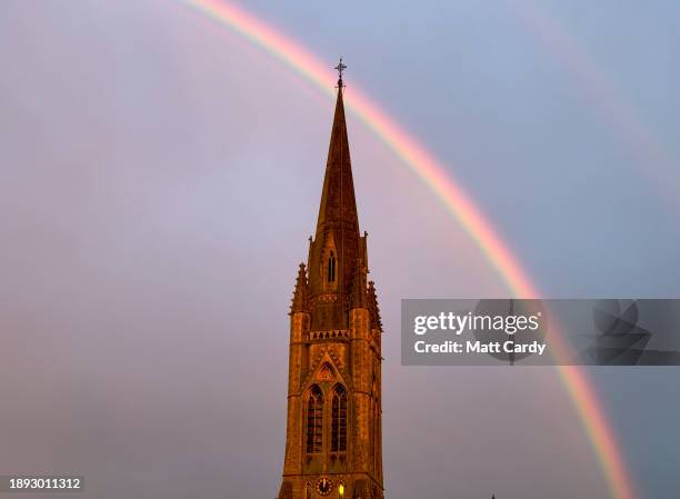 Rainbow is visible behind the spire of St John the Evangelist church on December 27, 2023 in Bath, England. Bath, a popular destination for tourists,...