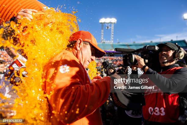 Head coach Dabo Swinney of the Clemson Tigers is dunked with Gatorade after defeating the Kentucky Wildcats 38-35 in the TaxSlayer Gator Bowl at...