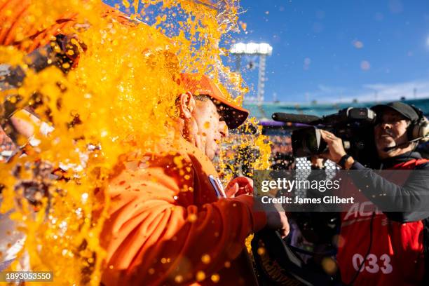 Head coach Dabo Swinney of the Clemson Tigers is dunked with Gatorade after defeating the Kentucky Wildcats 38-35 in the TaxSlayer Gator Bowl at...