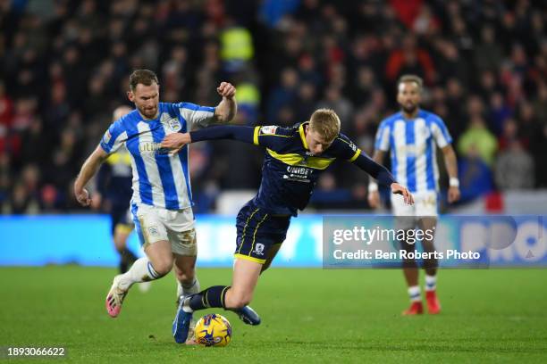 Tom Lees of Huddersfield Town challenges Josh Coburn of Middlesbrough during the Sky Bet Championship match between Huddersfield Town and...