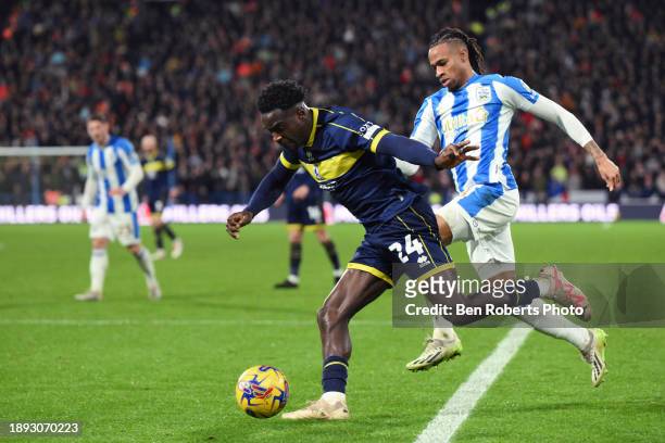 David Kasumu of Huddersfield Town challenges Alex Bangura of Middlesbrough during the Sky Bet Championship match between Huddersfield Town and...