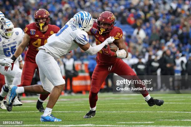 Abu Sama III of the Iowa State Cyclones carries the ball against Geoffrey Cantin-Arku of the Memphis Tigers during the first half of the 2023...