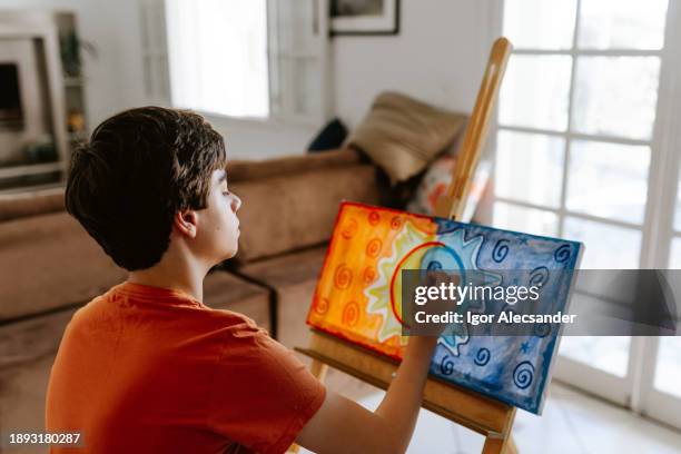 teenager painting a canvas at home - paintings stock pictures, royalty-free photos & images