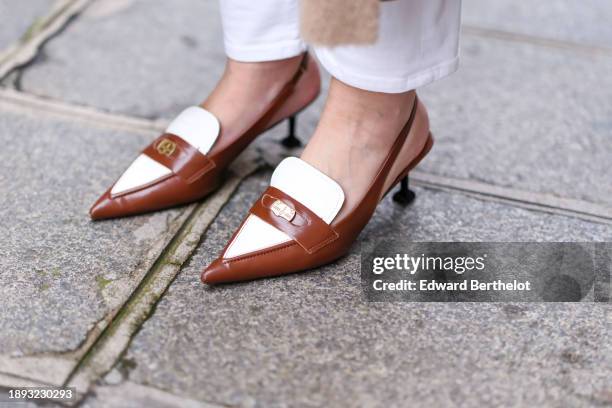 Alba Garavito Torre wears brown and white leather slingback moccasins with heels from Miu Miu, during a street style fashion photo session, on...
