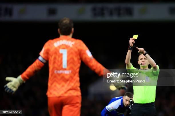 Asmir Begovic of Queens Park Rangers is shown a yellow card by Referee David Webb during the Sky Bet Championship match between Ipswich Town and...