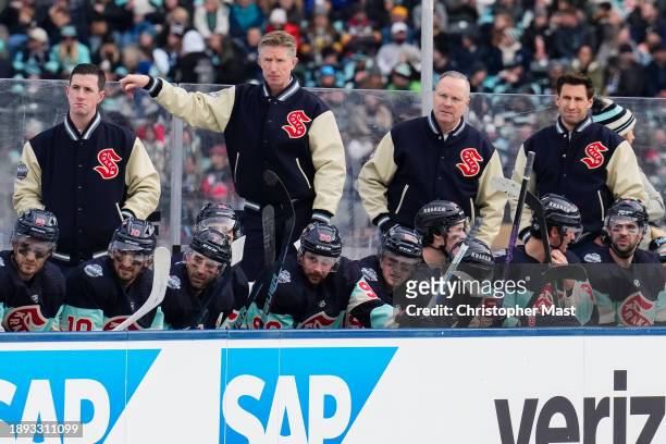 The Seattle Kraken look on from the home bench during the first period of the 2024 Discover NHL Winter Classic against the Vegas Golden Knights at...