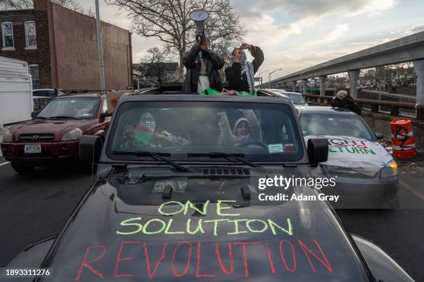 Supporters of Palestine drive in convoy near JFK Airport as they targeted the airport with protests on January 1, 2024 in New York City. More than...