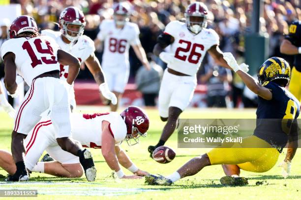Alabama Crimson Tide long snapper Kneeland Hibbett dives for a fumble on a punt return by Michigan Wolverines wide receiver Semaj Morgan during the...