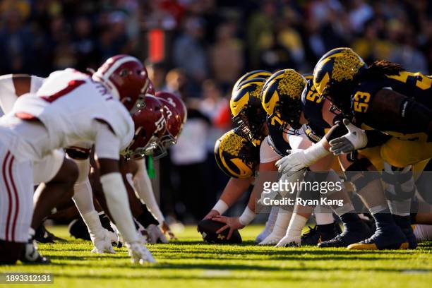 The Alabama Crimson Tide defensive line gets set at the line of scrimmage against the Michigan Wolverines offensive line during the CFP Semifinal...