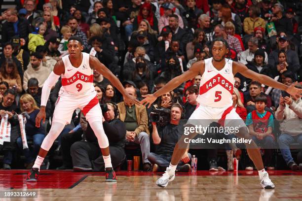 Barrett of the Toronto Raptors and Immanuel Quickley of the Toronto Raptors play defense against the Cleveland Cavaliers on January 1, 2024 at the...