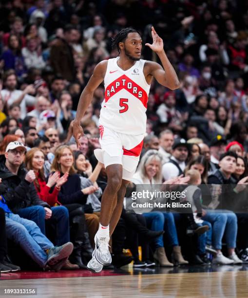 Immanuel Quickley of the Toronto Raptors celebrates a three point shot against the Cleveland Cavaliers during the first half of their basketball game...