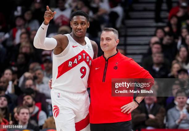 Barrett of the Toronto Raptors speaks with head coach Darko Rajakovic while playing against the Cleveland Cavaliers during the second half of their...