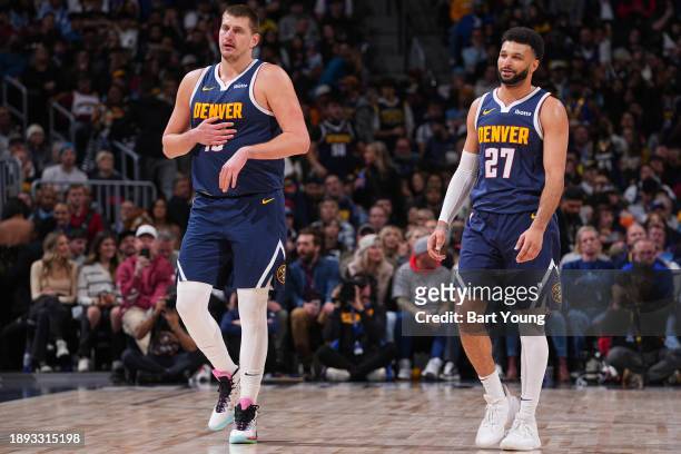 Nikola Jokic and Jamal Murray of the Denver Nuggets looks on during the game against the Charlotte Hornets on January 1, 2024 at the Ball Arena in...