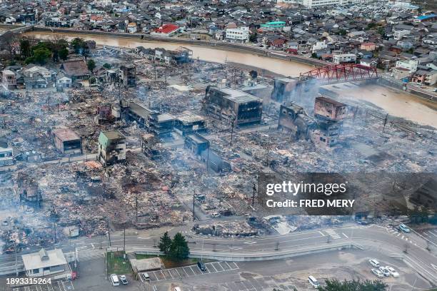 This aerial photo shows smoke rising from an area following a large fire in Wajima, Ishikawa prefecture on January 2 a day after a major 7.5...