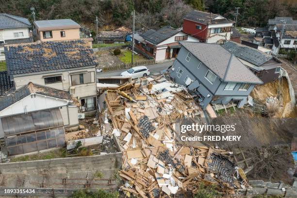 This aerial photo shows damaged and destroyed homes along a street in Wajima, Ishikawa prefecture on January 2 a day after a major 7.5 magnitude...