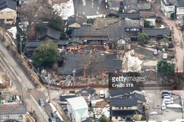 This aerial photo provided by Jiji Press shows a temple which appears to have collapsed in the city of Suzu, Ishikawa prefecture on January 2 a day...