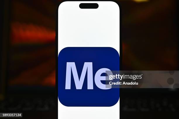 In this photo illustration logo of an 'Adobe' app is displayed on a mobile screen in front of a computer screen in Ankara, Turkiye on December 28,...