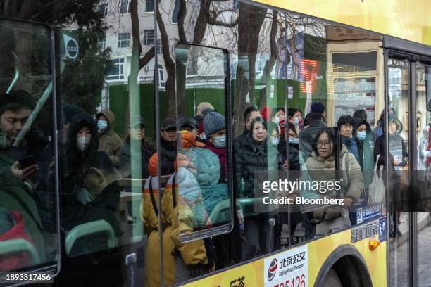 Pedestrians reflected in the window of a bus in Beijing, China, on Tuesday, Jan. 2, 2024. Chinese President Xi Jinping pledged to strengthen economic...