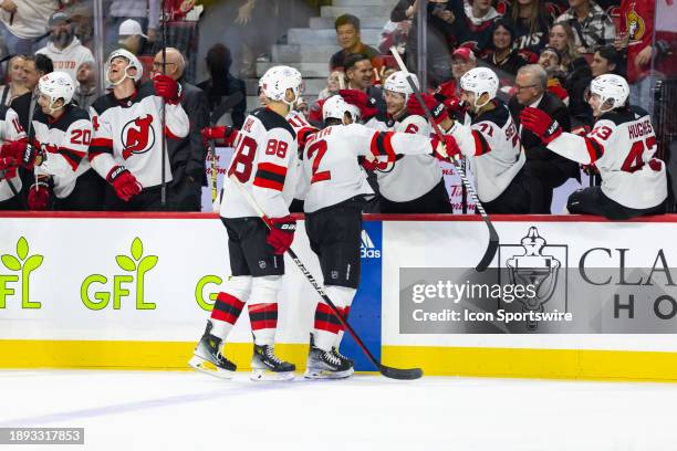 New Jersey Devils Defenceman Brendan Smith skates by the bench to celebrate a goal followed by Defenceman Kevin Bahl during third period National...