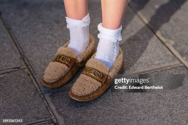 Natalia Verza wears white socks, shearling moccasin shoes from Tod's, a brown leather belt bag from Tod's, during a street style fashion photo...