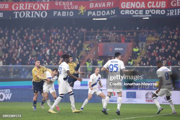 Johan Vasquez of Genoa CFC climbs above Yann Bisseck of FC Internazionale to head goalwards with his effort striking the hand of Marcus Thuram of FC...