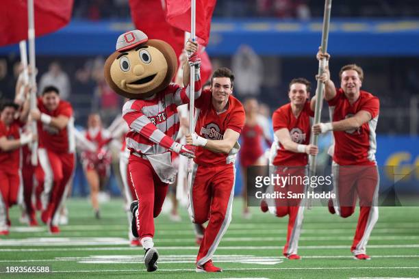 The Ohio State Buckeyes mascot and cheerleaders run onto the field prior to a game against the Missouri Tigers in the Goodyear Cotton Bowl at AT&T...