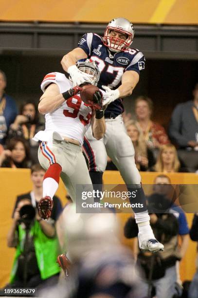 Chase Blackburn of the New York Giants intercepts a pass intended for Rob Gronkowski of the New England Patriots during Super Bowl XLVI at Lucas Oil...