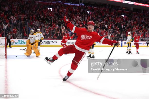 Lucas Raymond of the Detroit Red Wings celebrates his game winning goal in overtime in front of Juuse Saros of the Nashville Predators at Little...