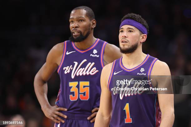 Devin Booker and Kevin Durant of the Phoenix Suns on the court during the first half of the NBA game against the Charlotte Hornets at Footprint...