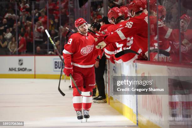 Alex DeBrincat of the Detroit Red Wings celebrates his third period goal with teammates while playing the Nashville Predators at Little Caesars Arena...