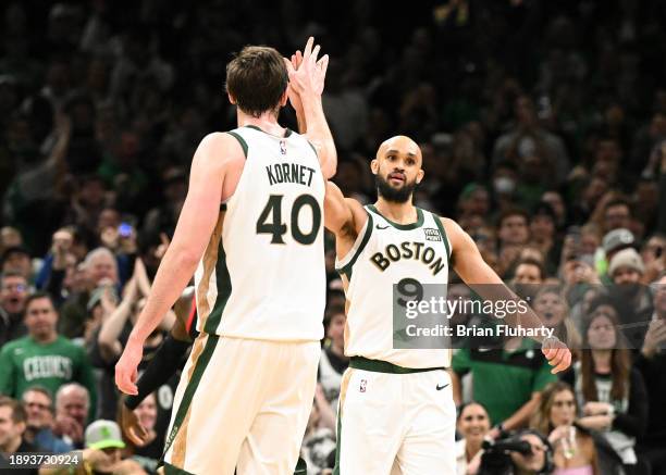 Derrick White of the Boston Celtics high-fives Luke Kornet after a score during the fourth quarter of a game against the Toronto Raptors at the TD...