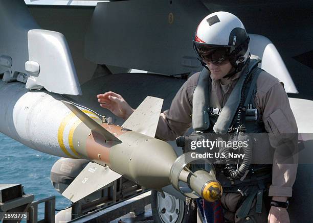 Naval Aviator inspects ordnance on an F/A-18F Super Hornet prior to taking off on his next mission April 2, 2003 aboard USS Abraham Lincoln. Lincoln...