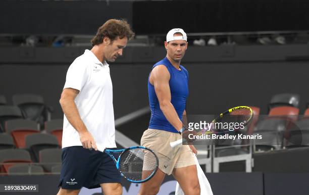 Rafael Nadal is seen chatting with his coach Carlos Moya during a practice match against Andy Murray ahead of the 2024 Brisbane International at...
