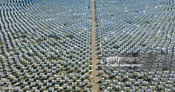 solar panels in ivanpah solar power facility on sunny day - aerial view - solar nevada stock pictures, royalty-free photos & images