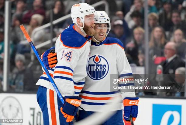 Evan Bouchard of the Edmonton Oilers is congratulated by Mattias Ekholm after Bouchard scored a goal against the San Jose Sharks during the first...