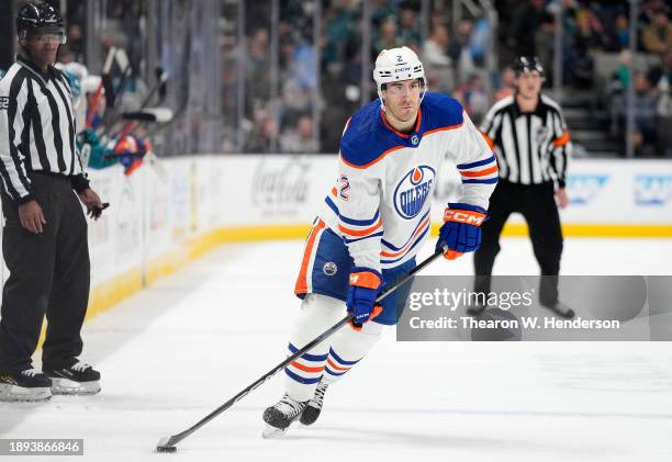 Evan Bouchard of the Edmonton Oilers skates with control of the puck against the San Jose Sharks during the first period of an NHL hockey game at SAP...