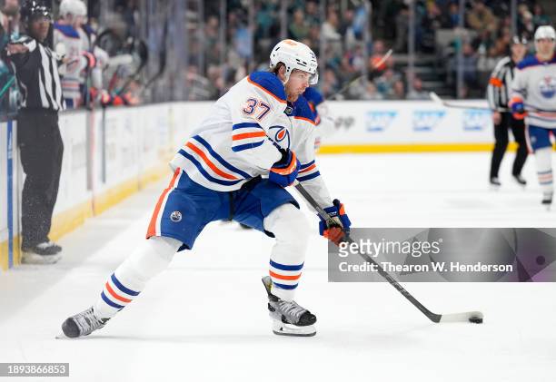 Warren Foegele of the Edmonton Oilers skates with control of the puck against the San Jose Sharks during the first period of an NHL hockey game at...