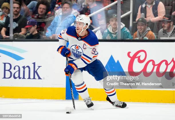 Connor McDavid of the Edmonton Oilers skates with control of the puck against the San Jose Sharks during the first period of an NHL hockey game at...