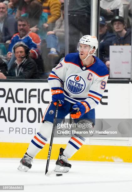 Connor McDavid of the Edmonton Oilers skates with control of the puck against the San Jose Sharks during the first period of an NHL hockey game at...