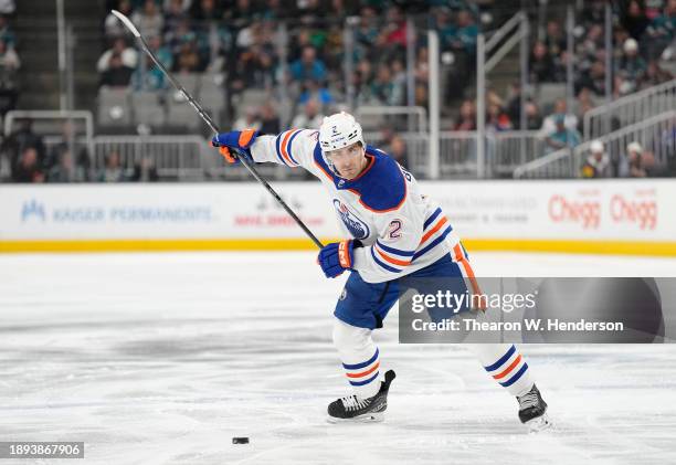 Evan Bouchard of the Edmonton Oilers looks to pass the puck against the San Jose Sharks during the first period of an NHL hockey game at SAP Center...