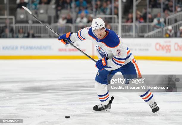 Evan Bouchard of the Edmonton Oilers looks to pass the puck against the San Jose Sharks during the first period of an NHL hockey game at SAP Center...