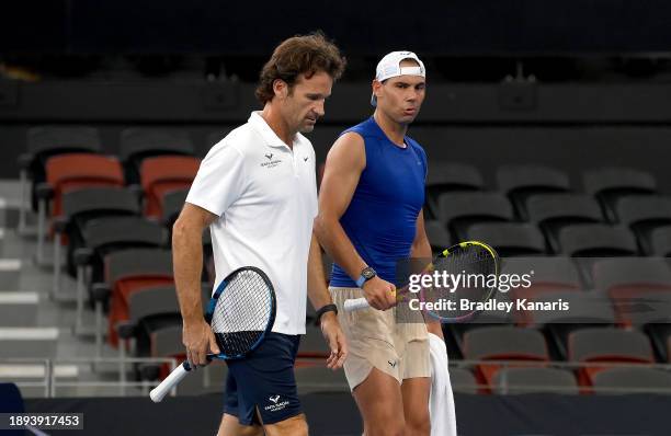 Rafael Nadal is seen chatting with his coach Carlos Moya during a practice match against Andy Murray ahead of the 2024 Brisbane International at...