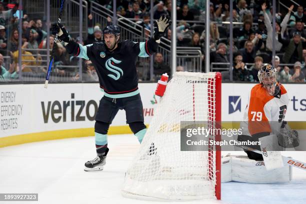 Justin Schultz of the Seattle Kraken celebrates his game-winning goal in overtime against Carter Hart of the Philadelphia Flyers at Climate Pledge...