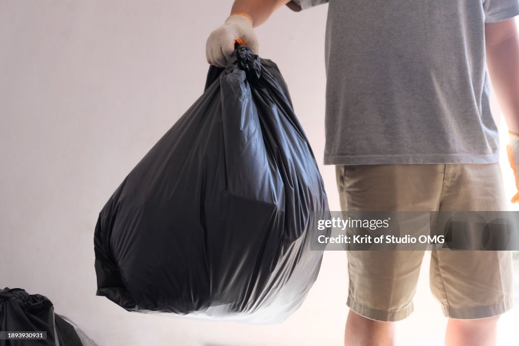 A man holding a garbage bag