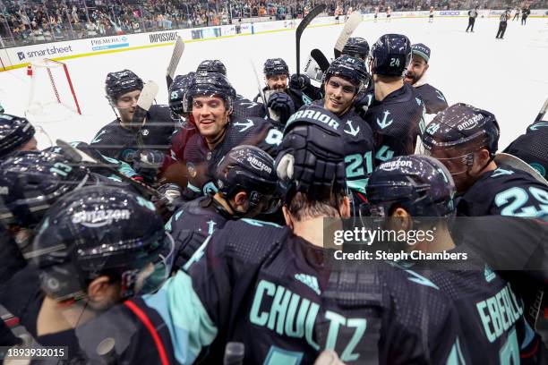 The Seattle Kraken bombard Justin Schultz after his game-winning goal in overtime against Carter Hart of the Philadelphia Flyers at Climate Pledge...